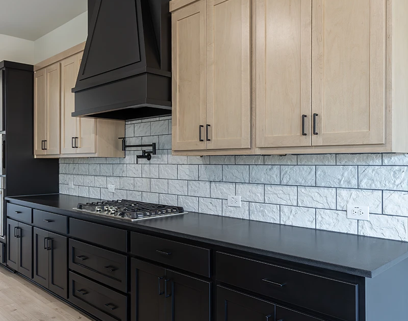 Kitchen cabinets Breu black base cabinets- Maple Savaii uppers -Breu Classic vent hood