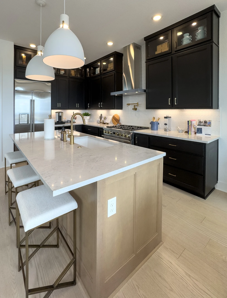 Kitchen with Maple Savaii island cabinets and Breu black perimeter cabinets with Callahan doors and gold hardware pulls