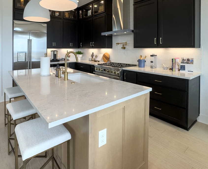 Kitchen with Maple Savaii island cabinets and Breu black perimeter cabinets with Callahan doors and gold hardware pulls