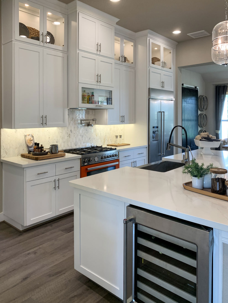 Kitchen with white cabinets, Shaker doors and wine refrigerator island