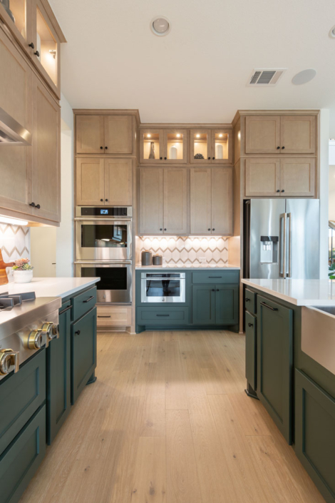Saba green painted island cabinets and maple Savaii perimeter kitchen cabinets with Shaker cabinet doors
