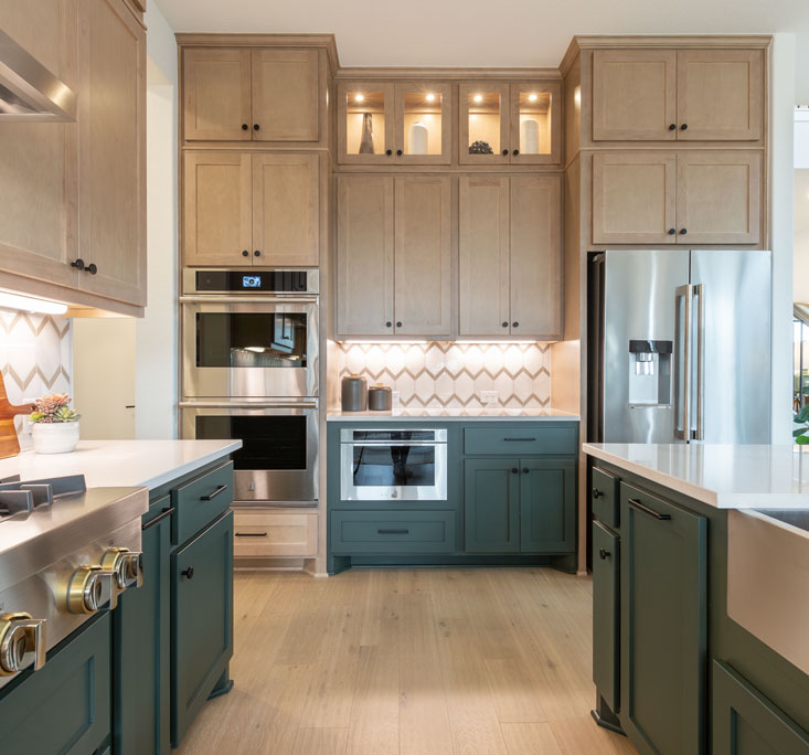 Saba green painted island cabinets and maple Savaii perimeter kitchen cabinets with Shaker cabinet doors