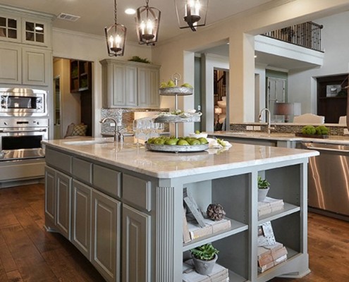 Burrows Cabinets kitchen island in Ecru with bookshelves and integrated corners