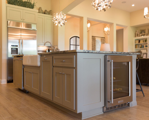 Burrows Cabinets' gray kitchen island with built in wine refrigerator