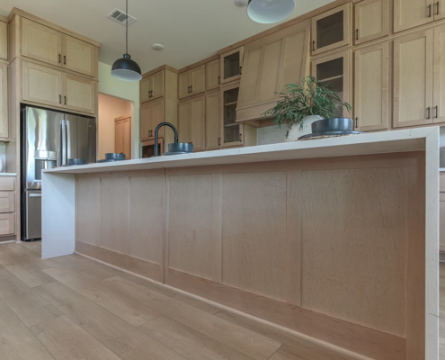 Kitchen island with paneled back in Maple Savaii