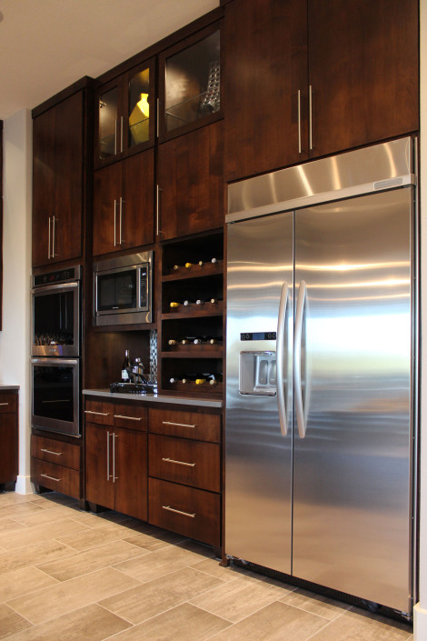 Burrows Cabinets kitchen with modern SoCo cabinet doors in knotty alder and scalloped wine rack