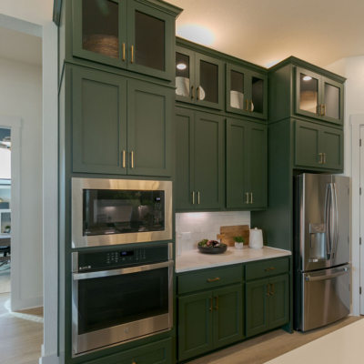 Tall built-in oven kitchen cabinets in Saba green with Shaker doors