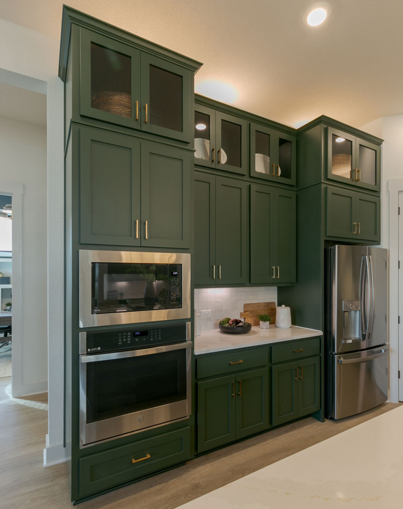 Tall built-in oven kitchen cabinets in Saba green with Shaker doors