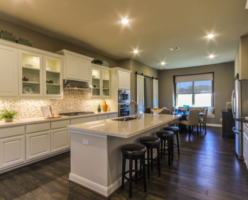 Burrows Cabinets' bone white kitchen with raised panel doors and glass inserts