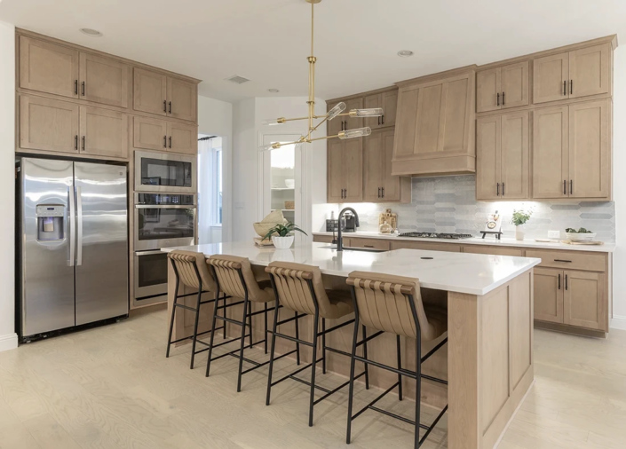 Kitchen cabinets and paneled island in Maple Savaii with Shaker doors and Artisan Hood