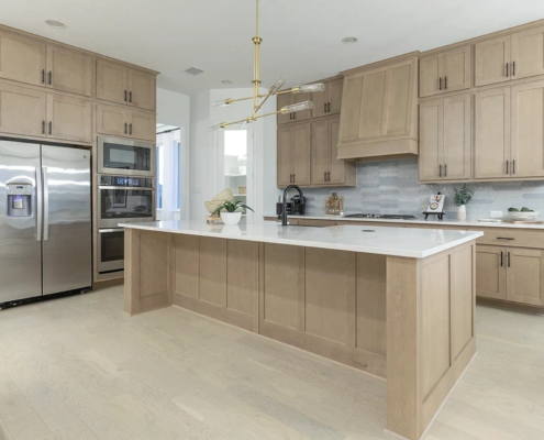 Kitchen island with paneled ends and back in Maple Savaii with Shaker doors