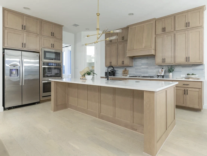 Kitchen island with paneled ends and back in Maple Savaii with Shaker doors