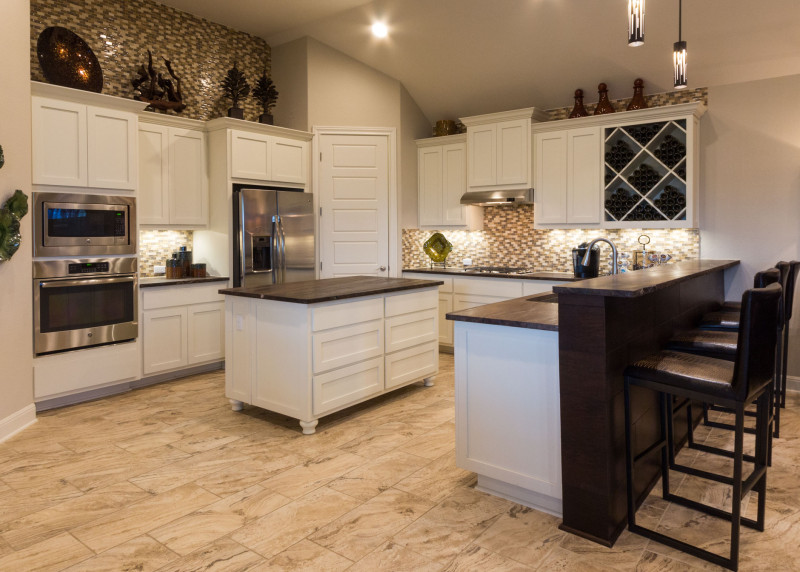 Burrows Cabinets' white kitchen with Big X wine rack and bunn feet on island