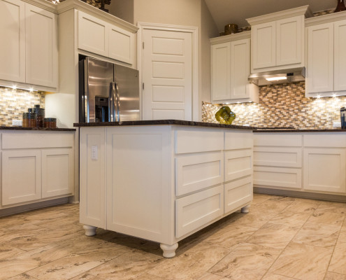 Burrows Cabinets' white kitchen with Shaker doors and Bunn feet on island
