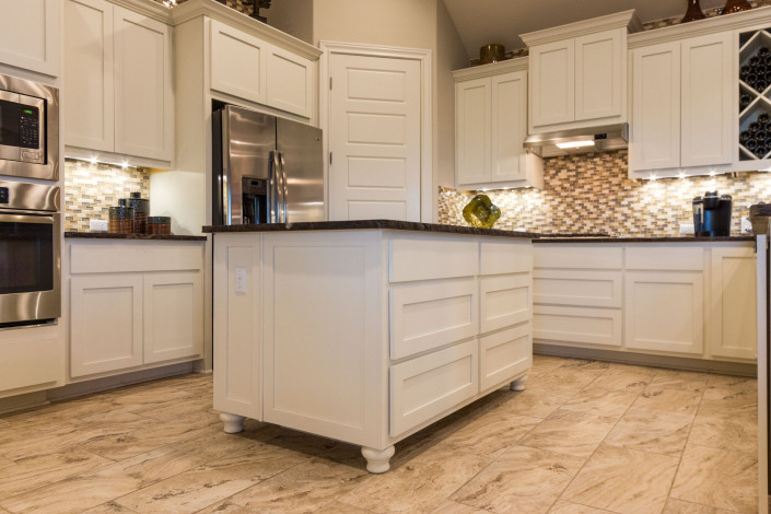 Burrows Cabinets' white kitchen with Shaker doors and Bunn feet on island