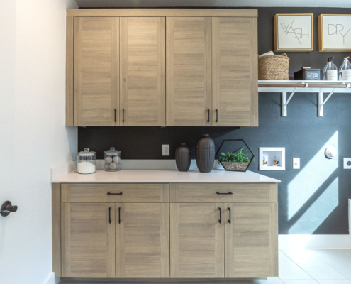 Laundry room cabinets in EVRGRN Laurent with 3-pc doors