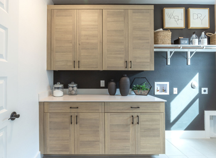 Laundry room cabinets in EVRGRN Laurent with 3-pc doors