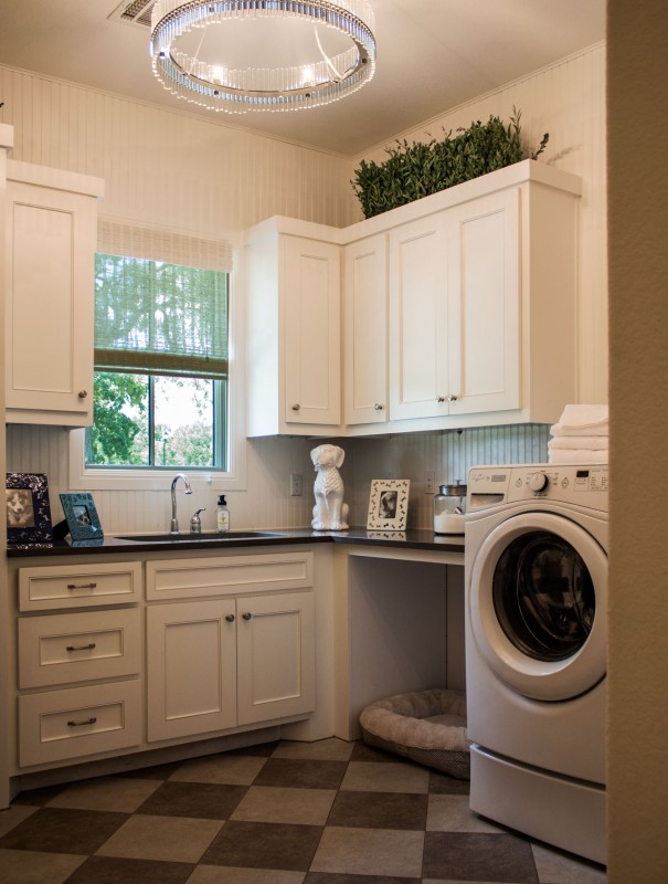 Burrows Cabinets' laundry room cabinets with Kensington doors and dog bed open space