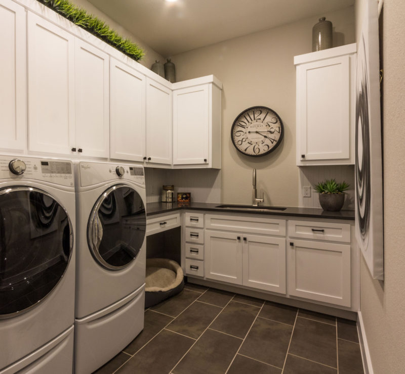 Burrows Cabinets' laundry room with shaker doors in bone white and dog bed space