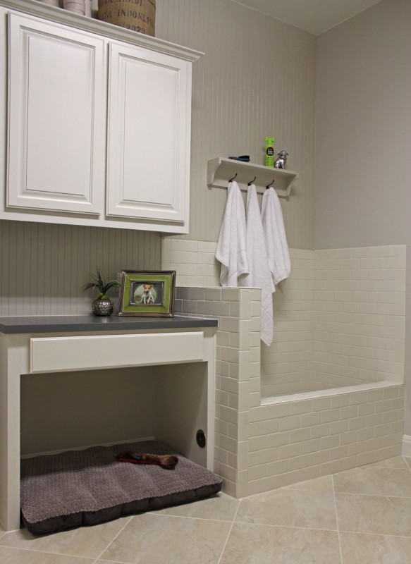 Burrows Cabinets' laundry room cabinets painted white with built-in dog shower