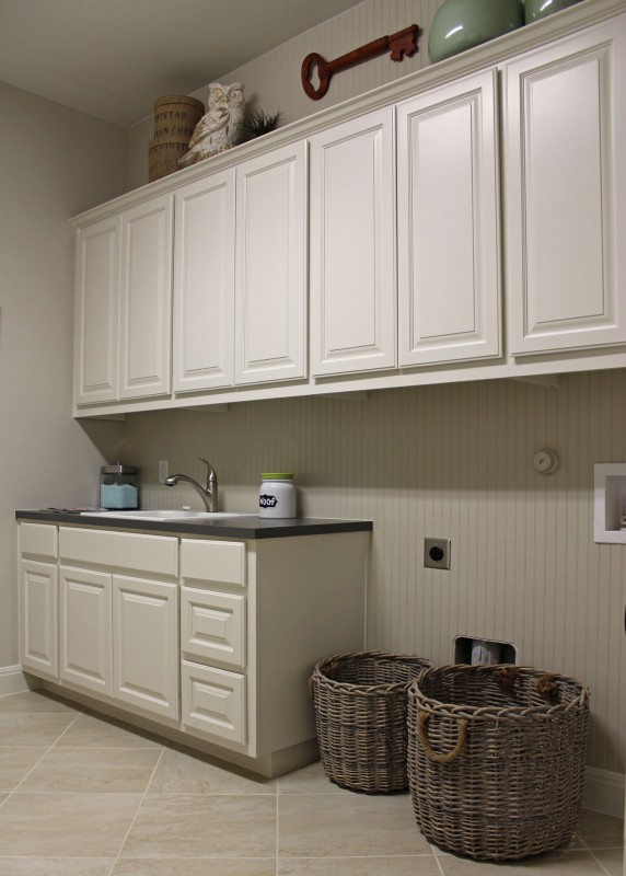 Burrows Cabinets' laundry room cabinets painted white with built-in sink