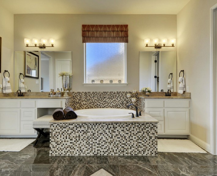 Burrows Cabinets' master bath in bone with knee space