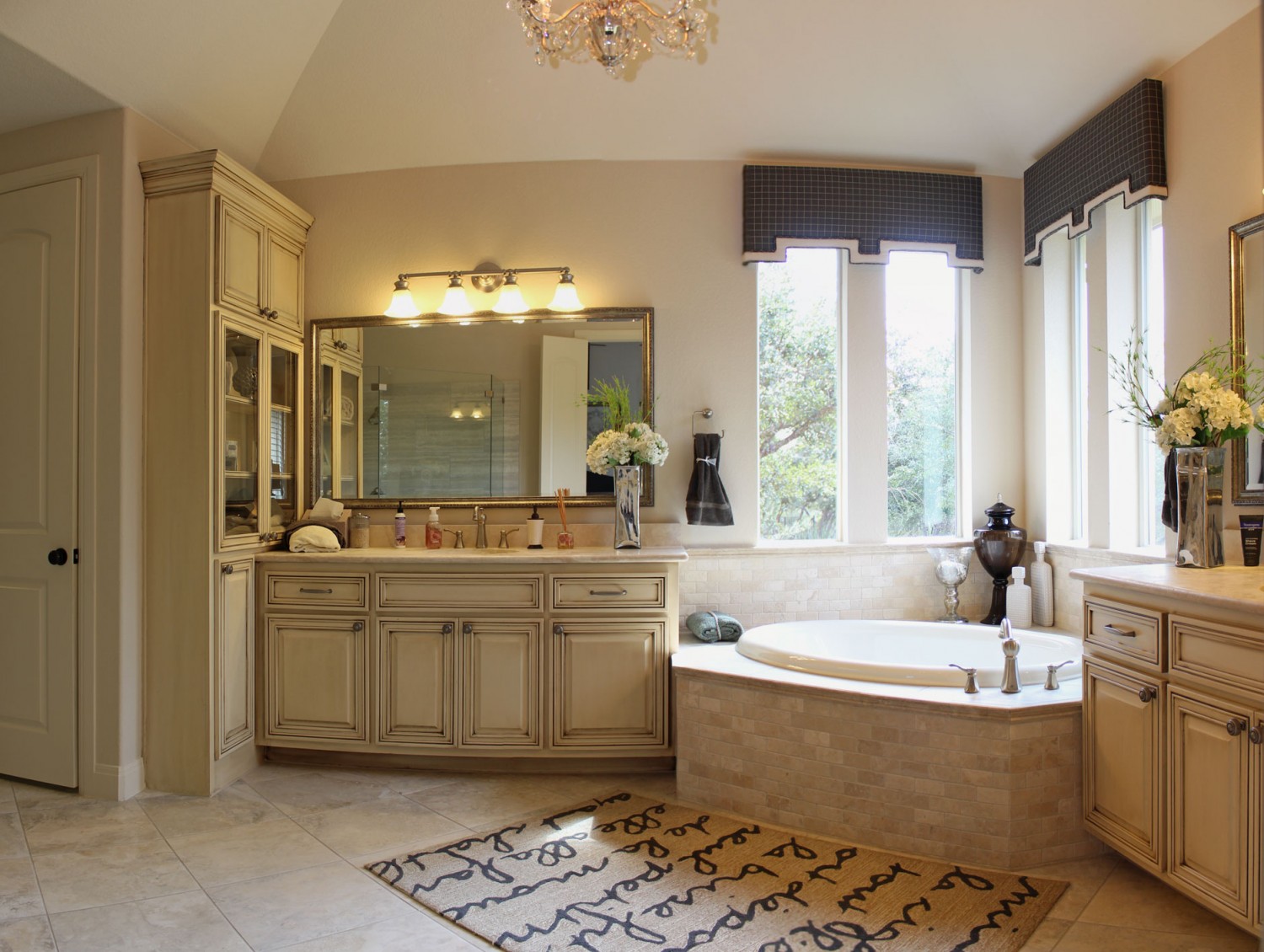 Master bath cabinets in bone white with tall glass door cabinet