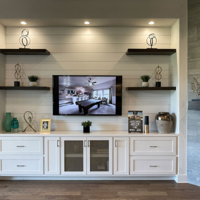 White media cabinets with shaker doors and floating shelves