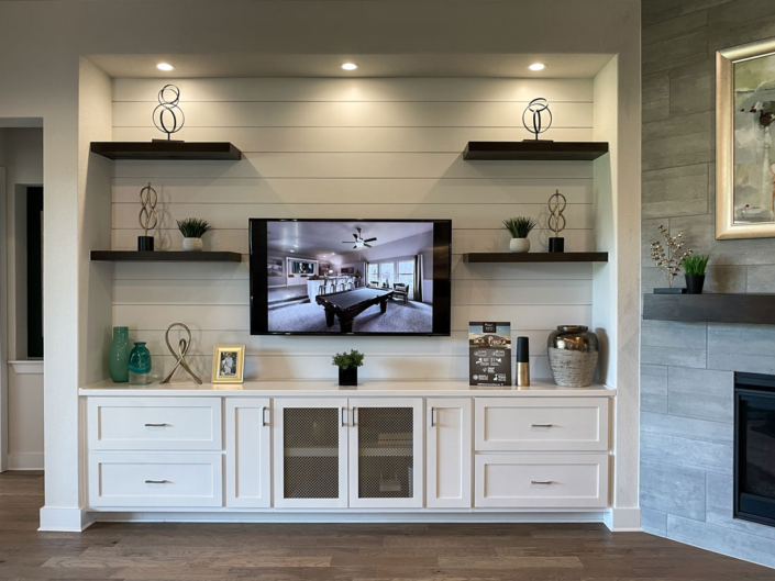 White media cabinets with shaker doors and floating shelves