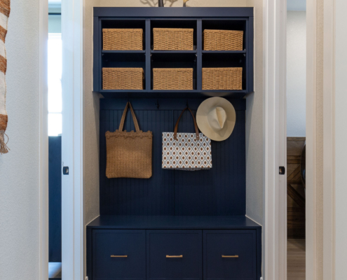 Mud room bench seat cabinets in Naval blue with Slim Shaker doors and gold pulls