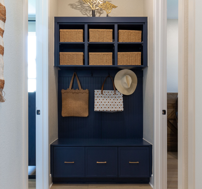 Mud room bench seat cabinets in Naval blue with Slim Shaker doors and gold pulls