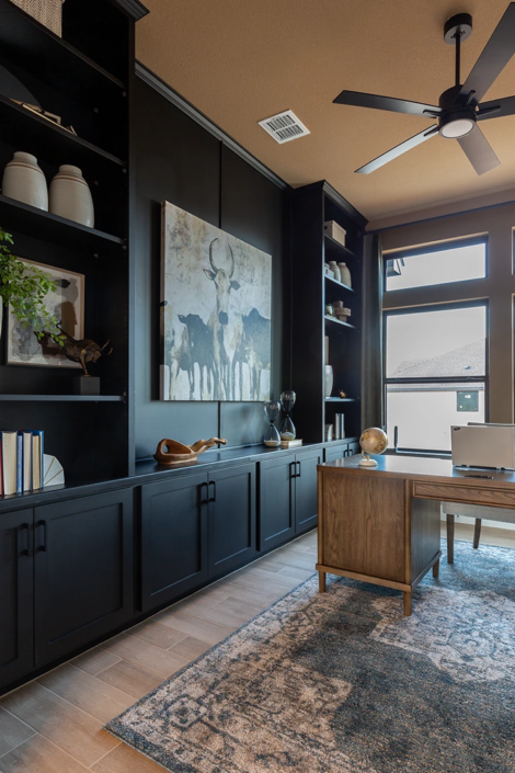 Custom, built-in office wall cabinets with closed base cabinets and open shelving on uppers in Breu soft black paint