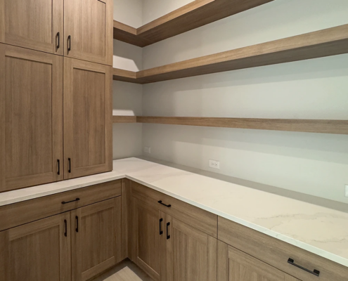 Pantry with built in cabinets in Reveur with 5 piece doors and floating shelves
