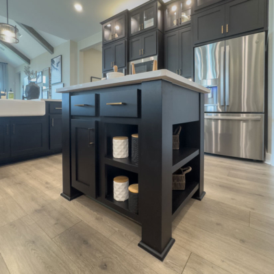 Small kitchen island in Breu black paint with Shaker doors and gold hardware 