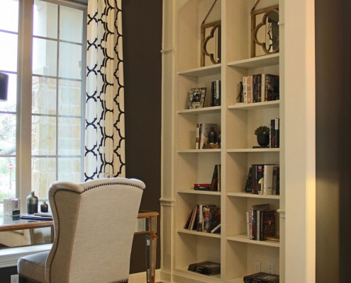 Burrows Cabinets' built-in bookshelves with arched top in bone white