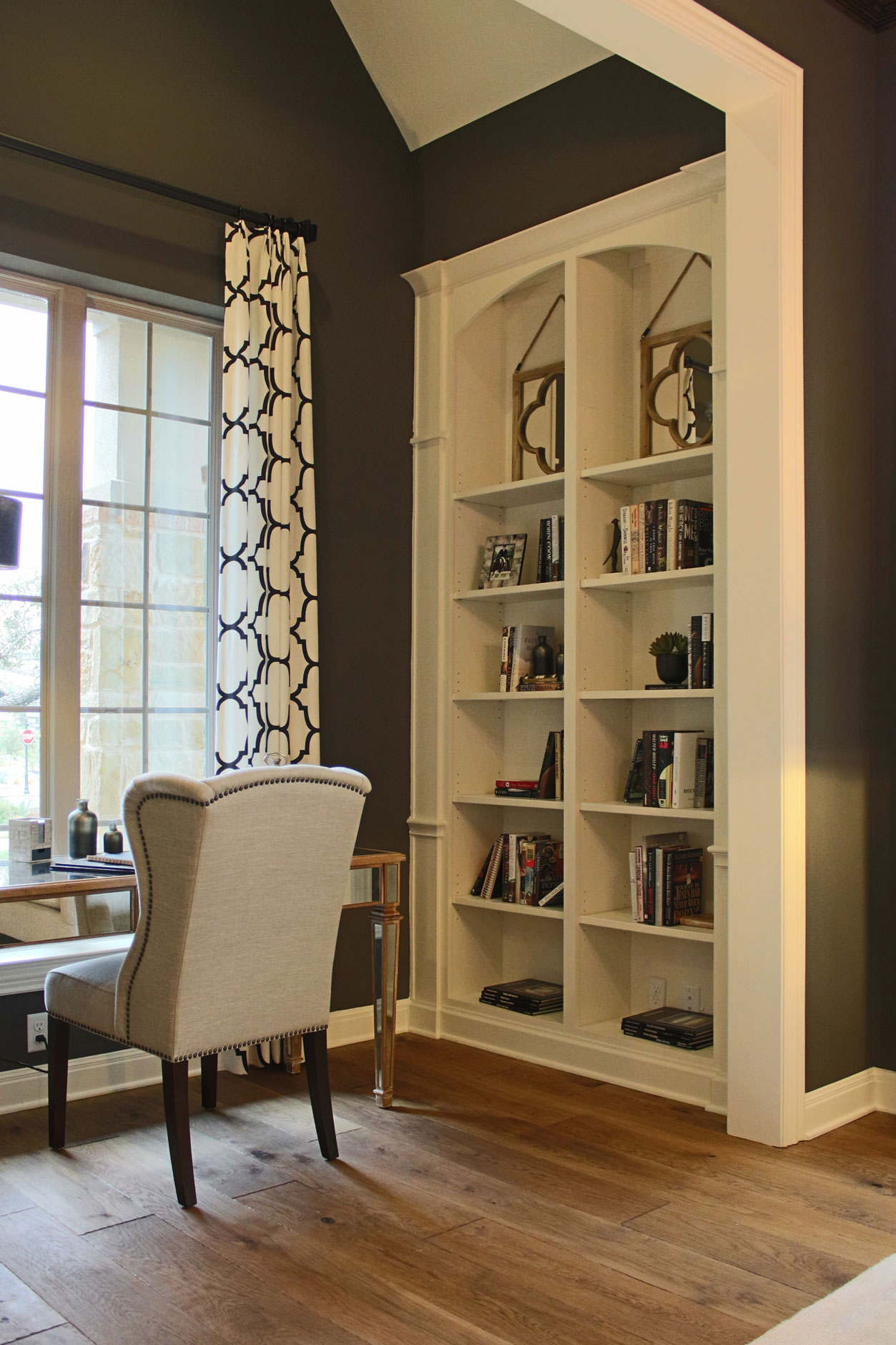 Built-in office bookshelves with arched top in bone white