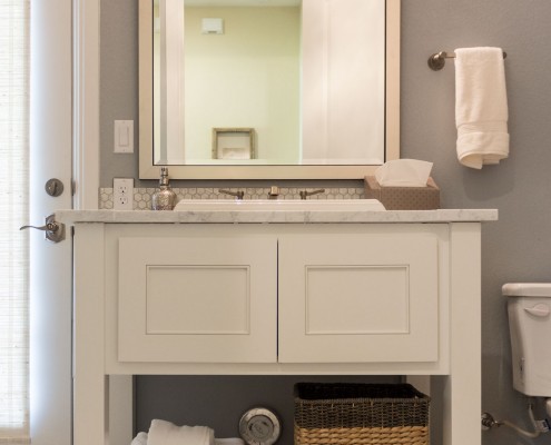Burrows Cabinets' bathroom vanity with Kensington doors and open storage